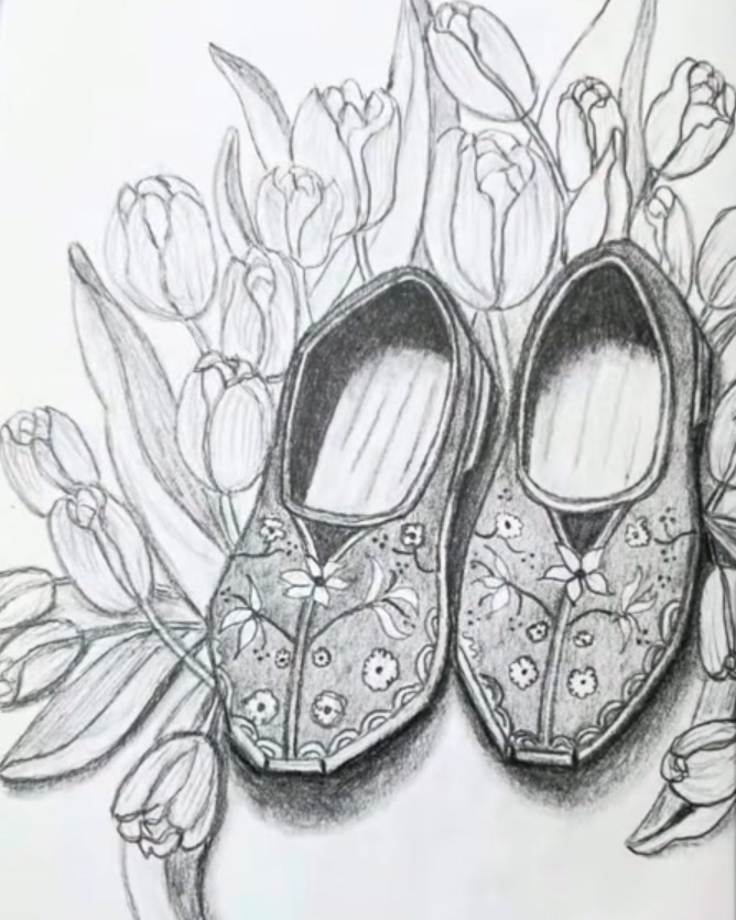 The finished pencil drawing: two Dutch clogs decorated with painted flowers, leaves and dots, standing among closed tulips with long leaves