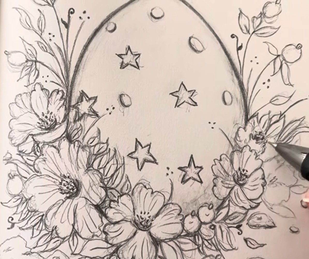 Graphite pencil drawing of an Easter egg with stars and dots, surrounded by a wreath of flowers, leaves, berries and buds