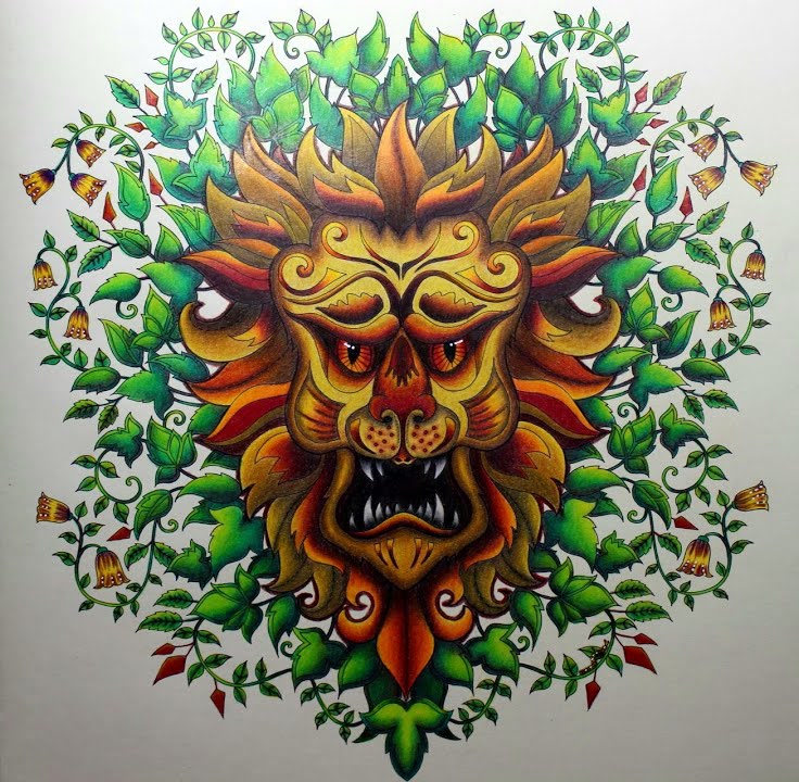 The finished Lion page: a golden-yellow lion face with orange eyes, sharp white teeth and a mane in orange, red and brown, framed by bright green leaves, curling vines and little yellow bell flowers