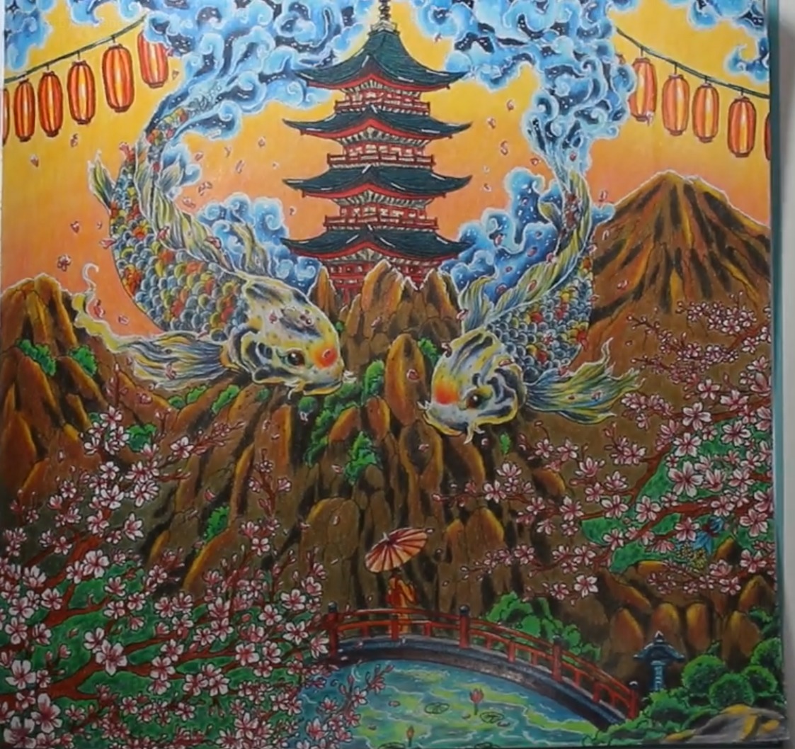 The finished Sunrise in Japan page: a golden orange sky with red lanterns, two yellow and blue koi fish curling around a pagoda, rocky brown mountains, pink cherry blossoms, a figure with a parasol and a red bridge over a green pond