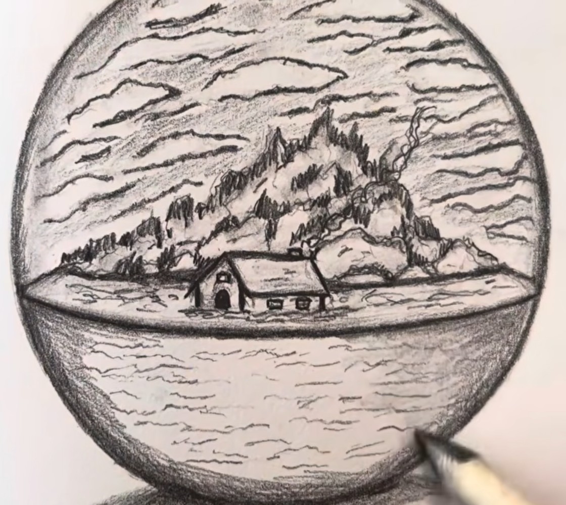 Graphite pencil drawing of a glass ball with a small cabin on the shore, a rocky wooded mountain and a cloudy sky above and rippling water below, on a sketchbook page