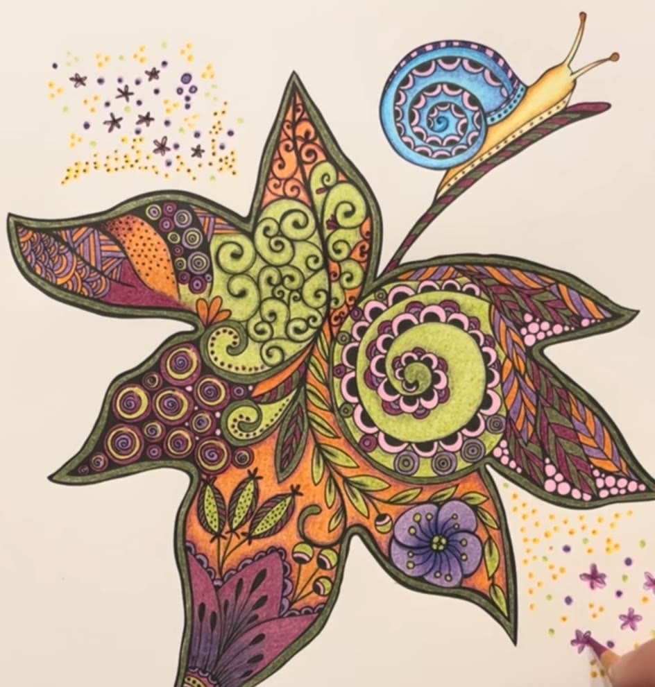 Zentangle autumn leaf from Rita Berman’s Mein Herbstspaziergang, colored in orange, lime green and purple Polychromos, with a blue snail, by Marah Maitale Art