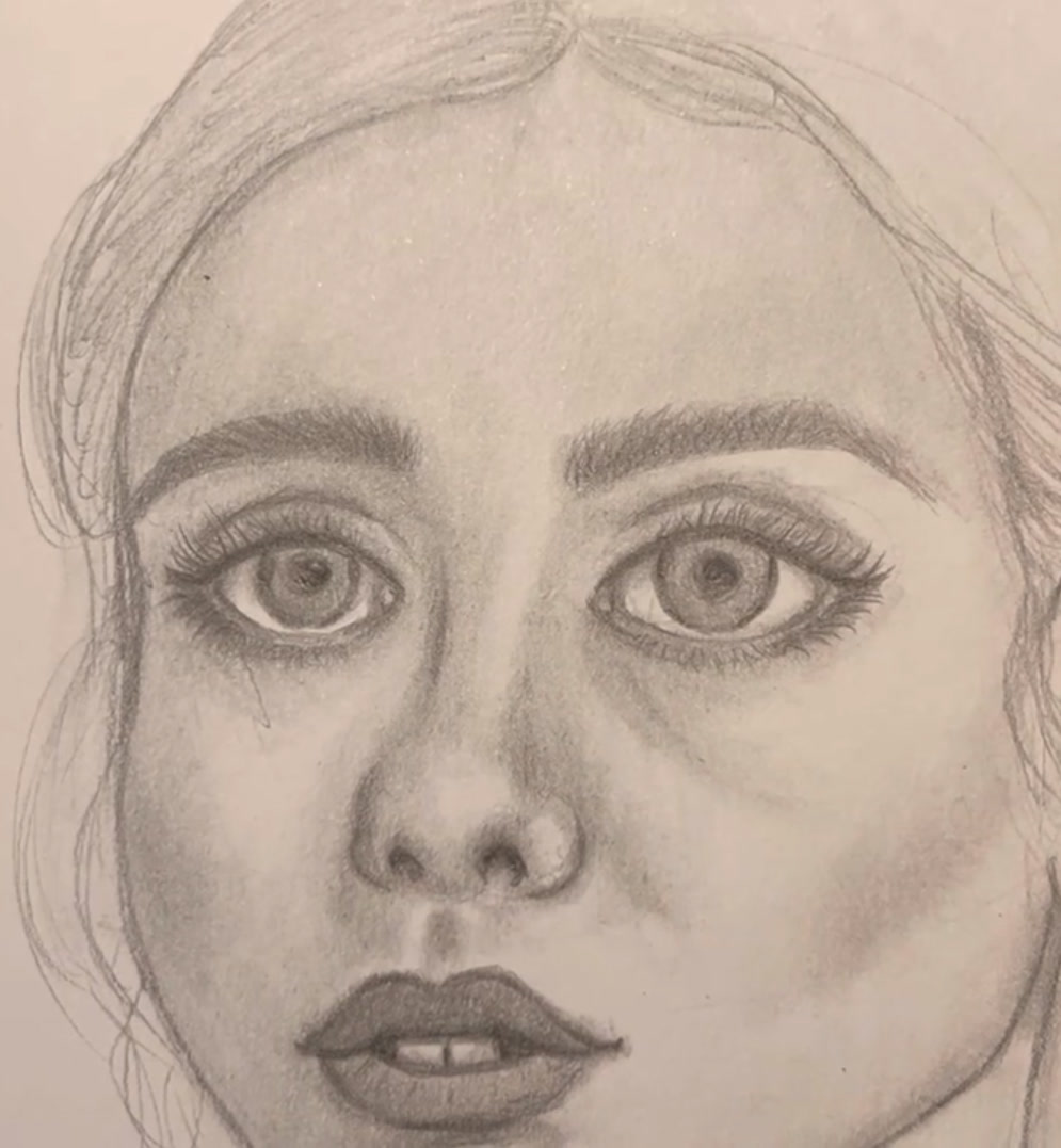 Graphite pencil portrait of a young woman with large shaded eyes, long lashes, full lips and sketched hair with a centre parting